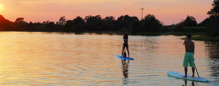 stand up paddleboarding sunset