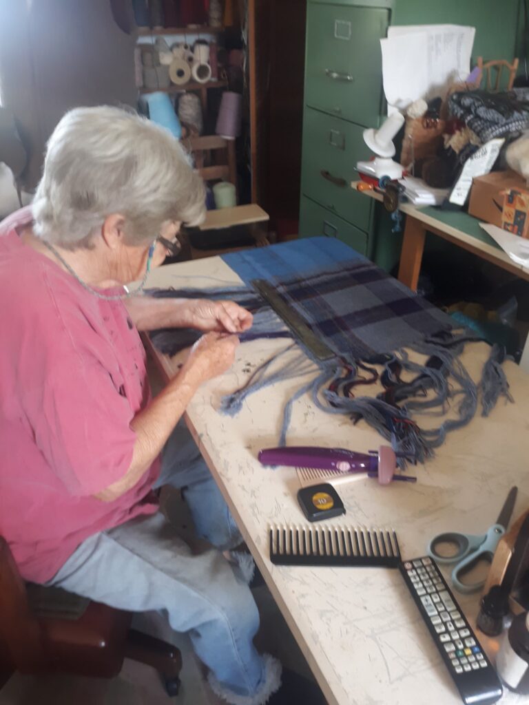 Rosalie Brown demonstrating a weaving technique