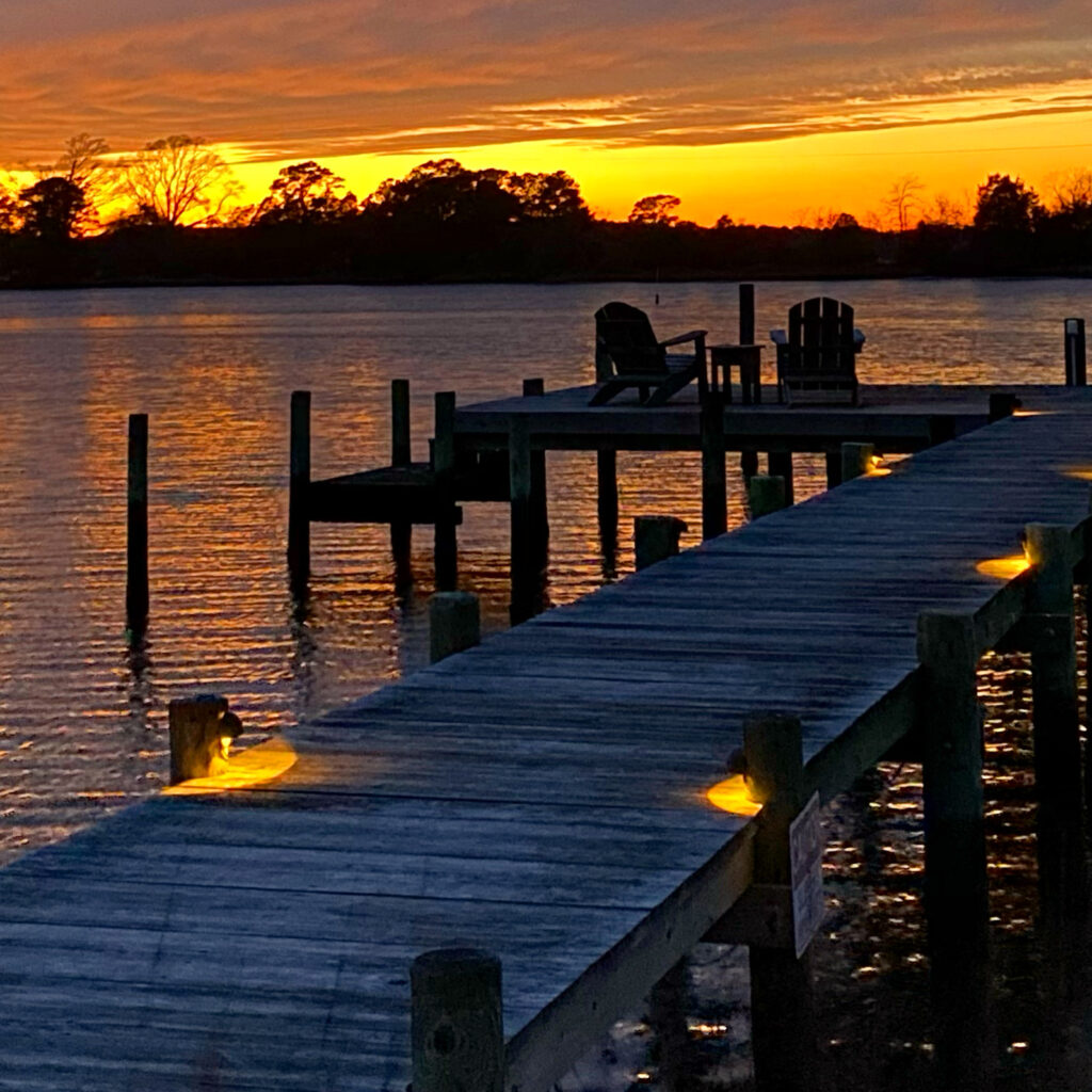 Sunset over our dock, view seen from back porch of Inn and pub room. 