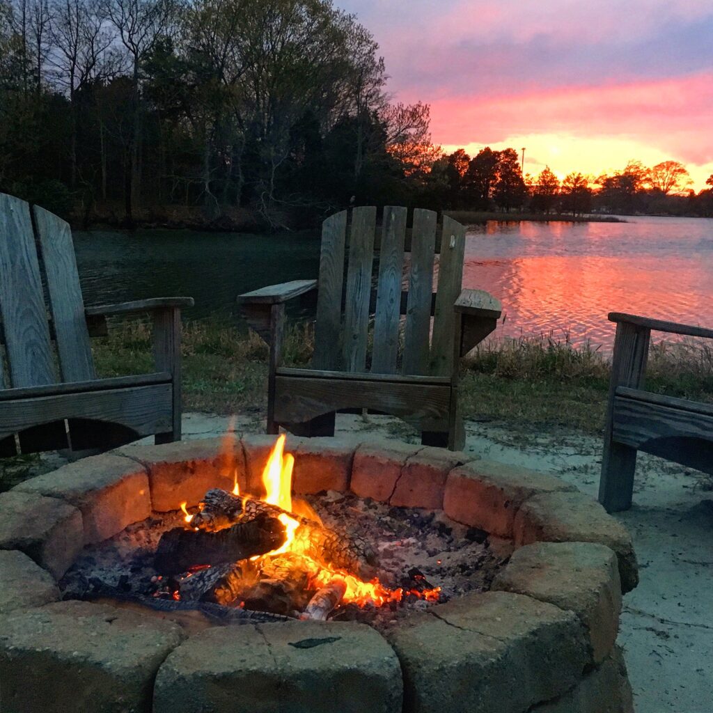 waterside fire pit with sunset