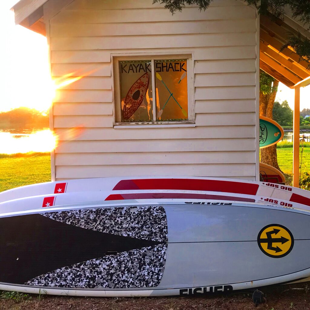 sup boards outside kayak shack