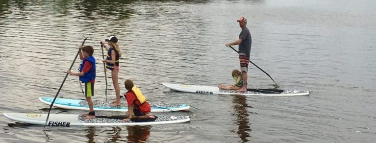 Family paddleboarding together