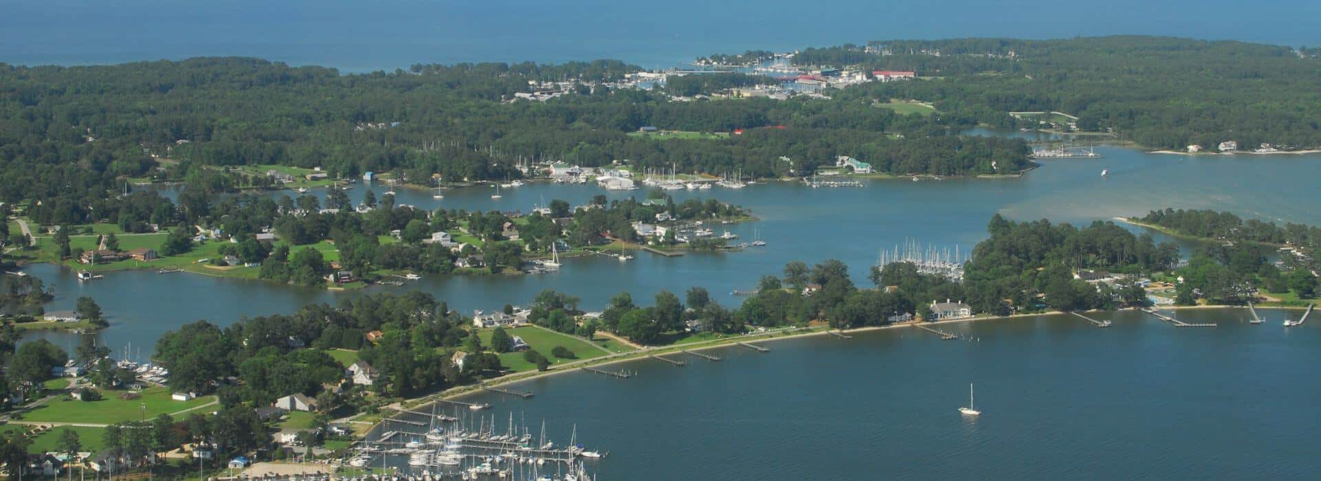 Aerial view of coastal town with multiple marinas